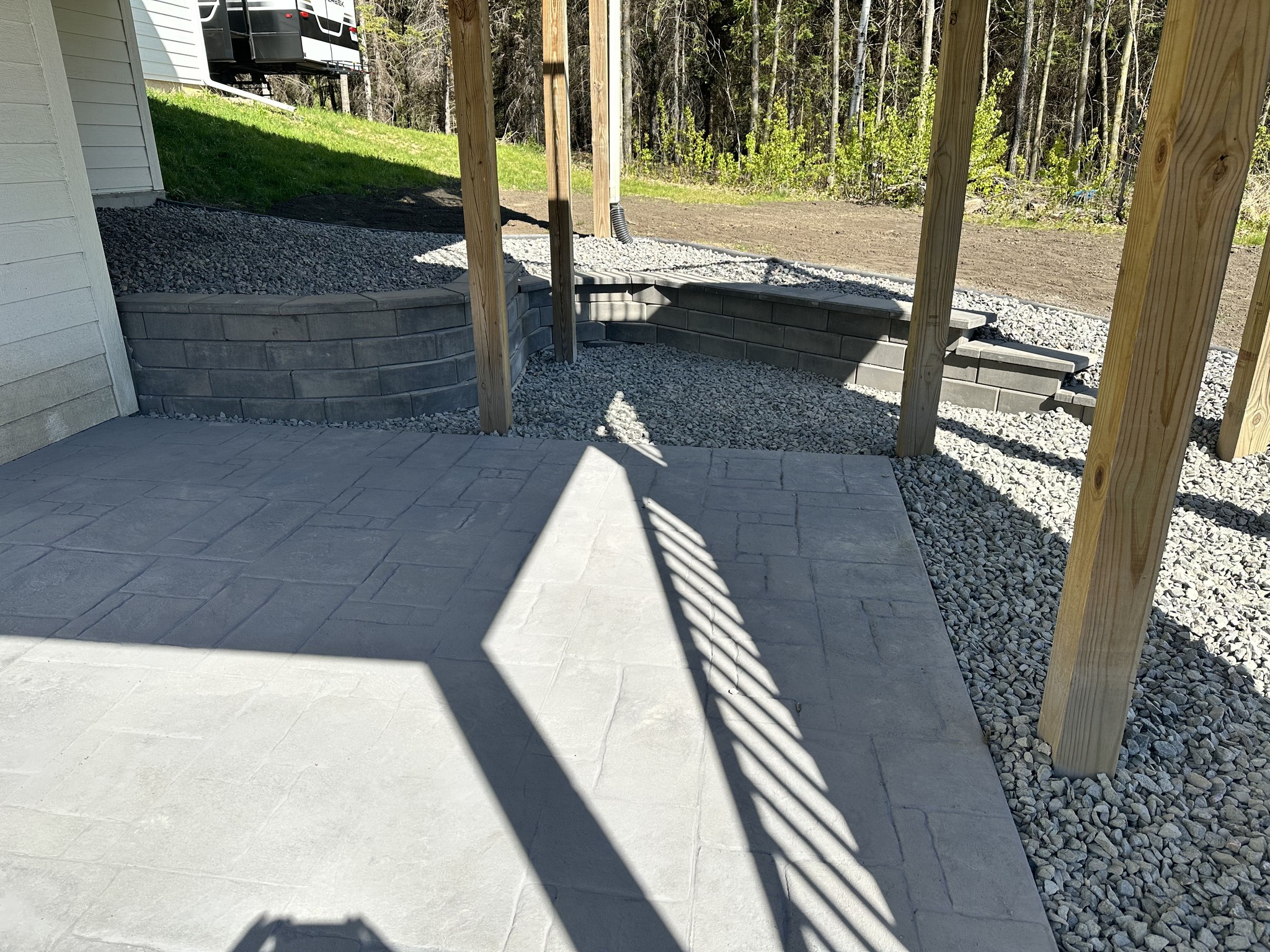 Before: bare dirt slope with skid steer ready for the build